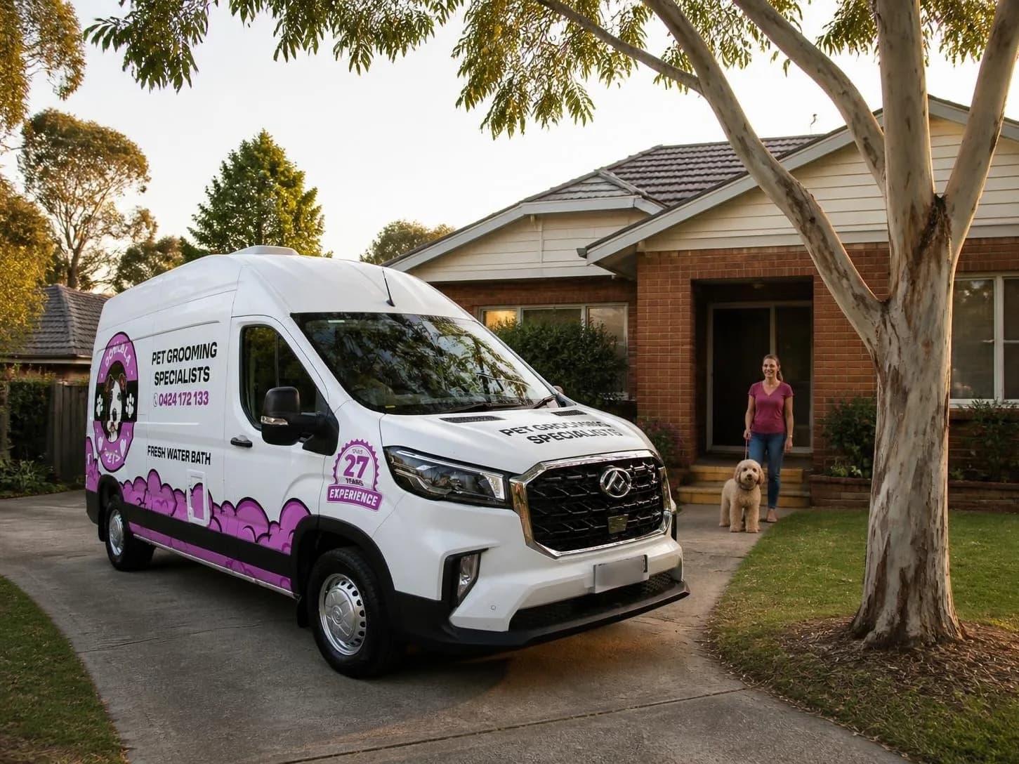 Dog grooming van in operator livery outside a suburban house