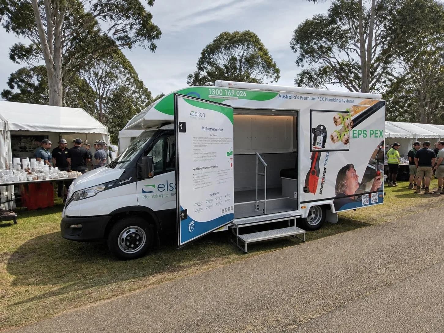 Elson mobile showroom with the side open at an outdoor event, and steps down to the display